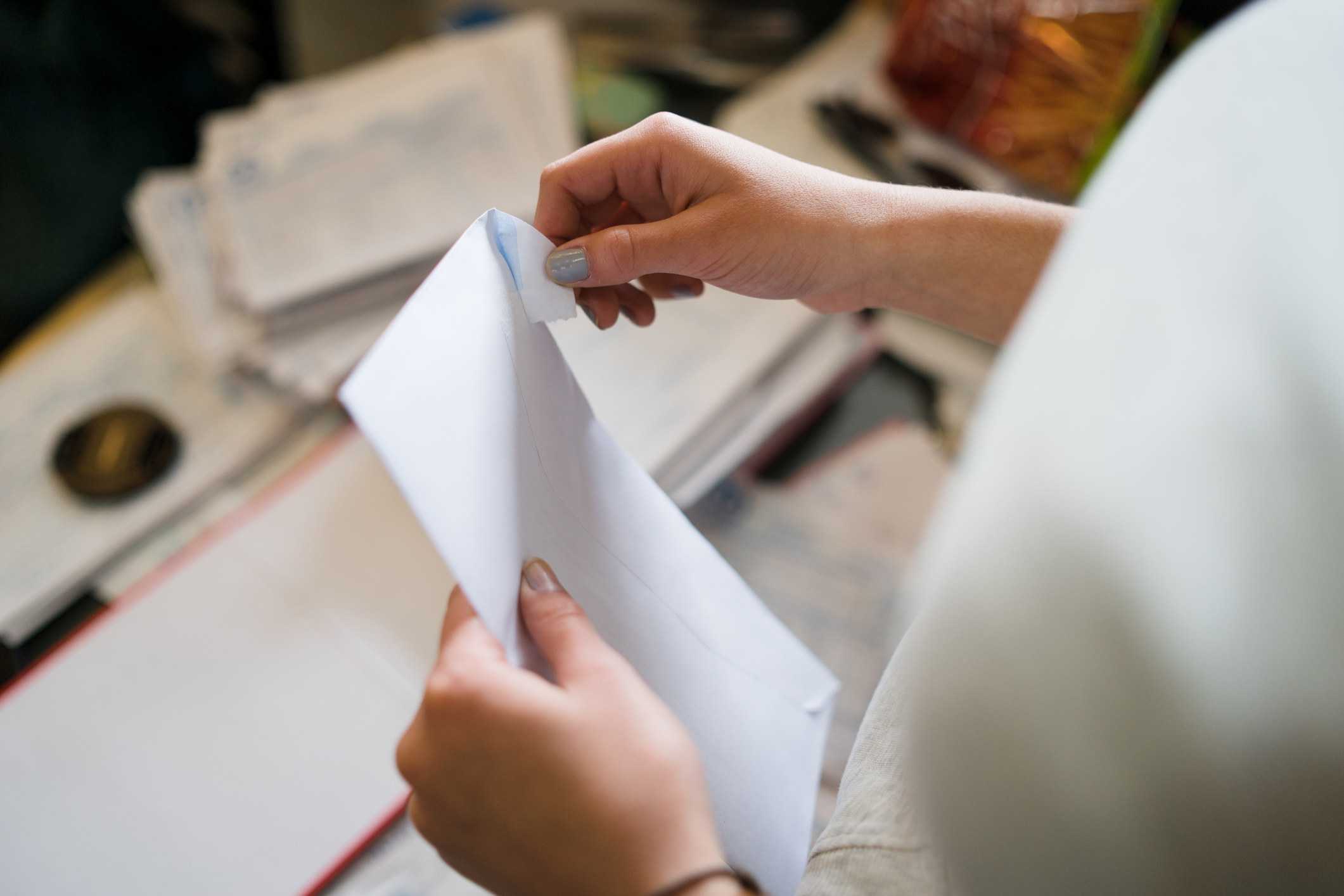 person opening an envelope