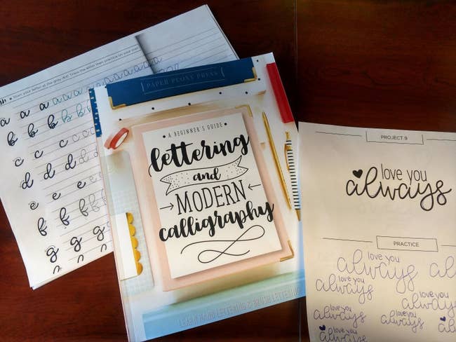 reviewer photo of the book with practice lettering next to it