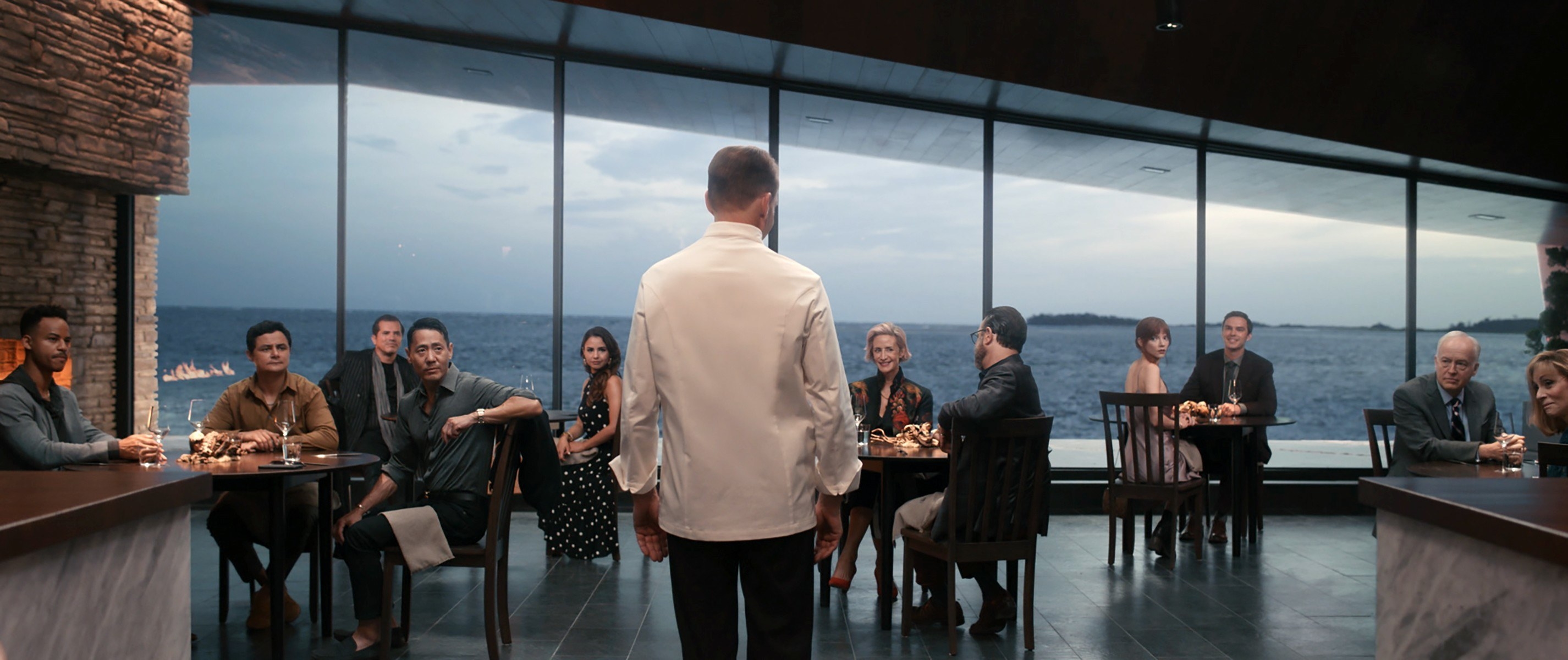 The dinner guests giving their attention to the chef