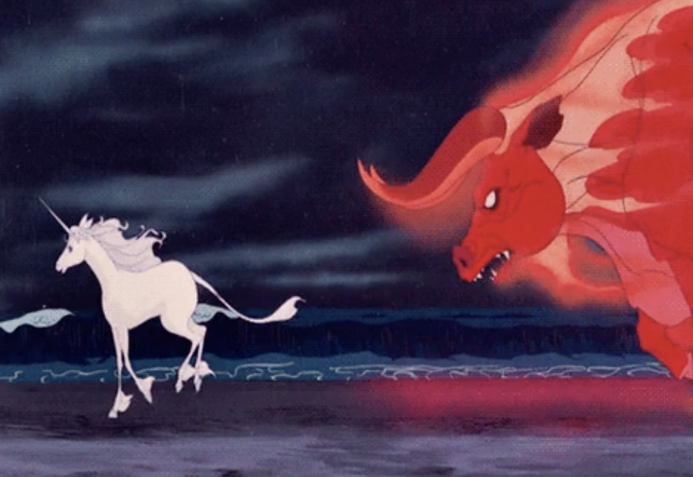a dragon looking angrily at a unicorn on a beach