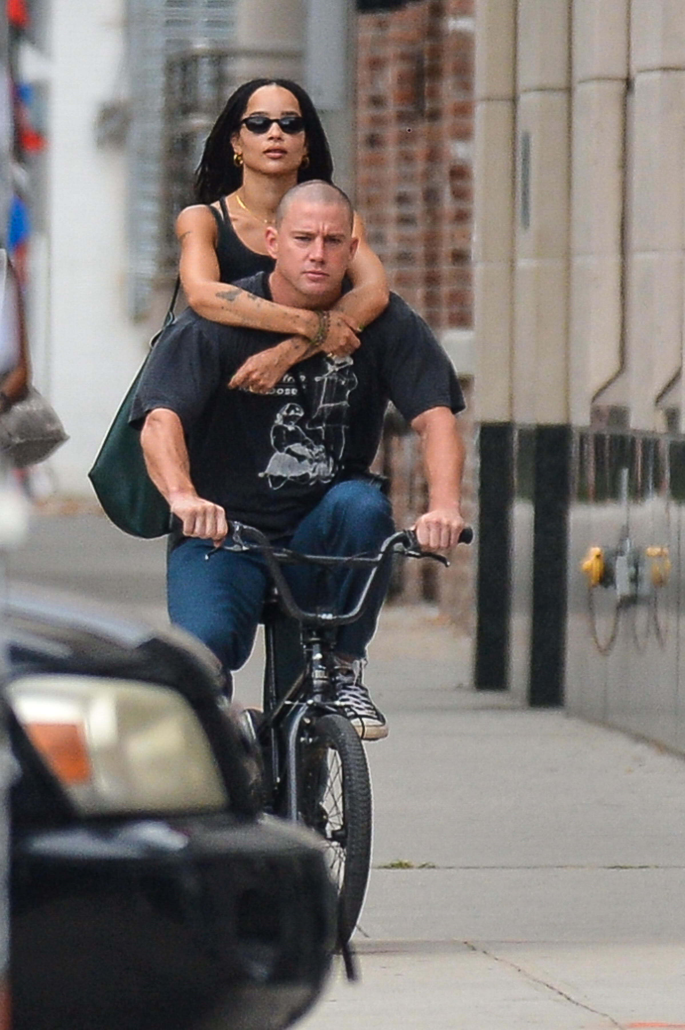 Zoe rides on the back of Channing&#x27;s bike