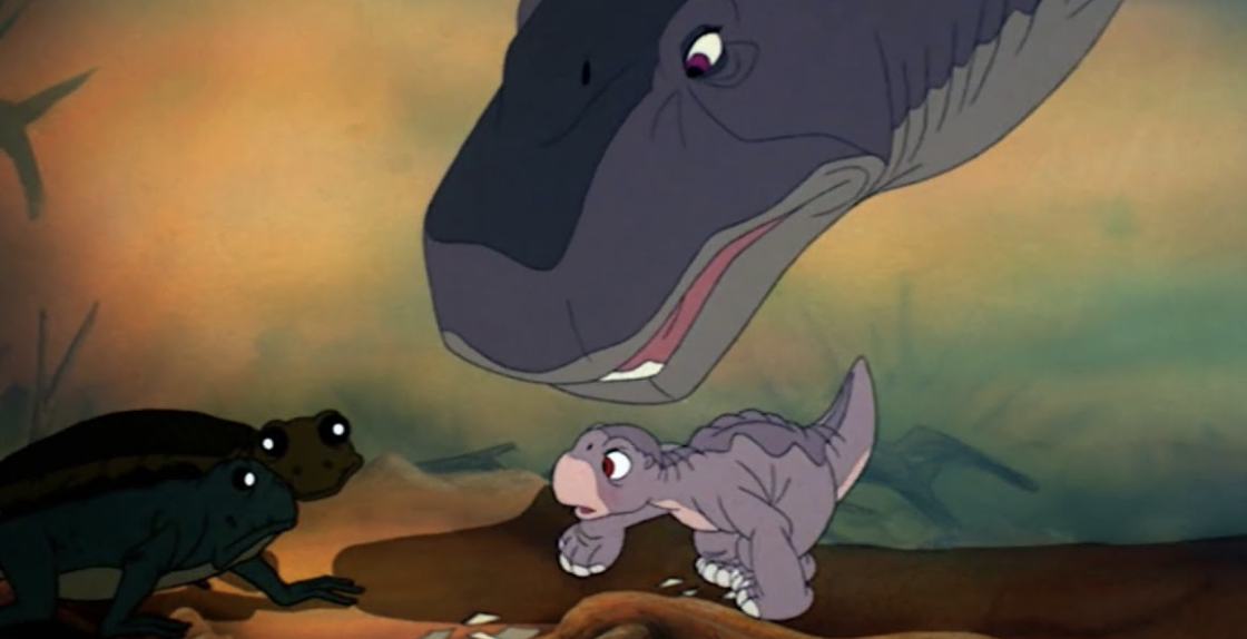 an adult dinosaur with a baby one and two frogs