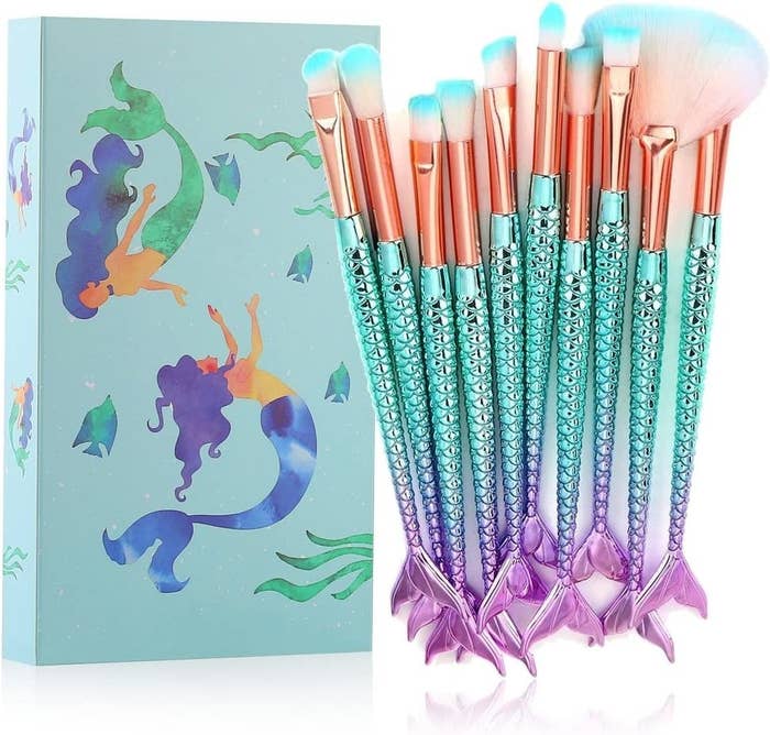 the mermaid makeup brushes and the box against a plain background