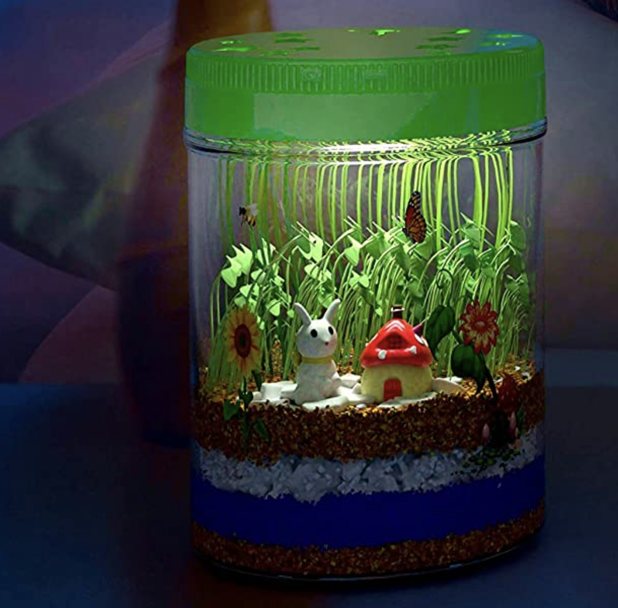 the light up terrarium in the dark on a bedside table