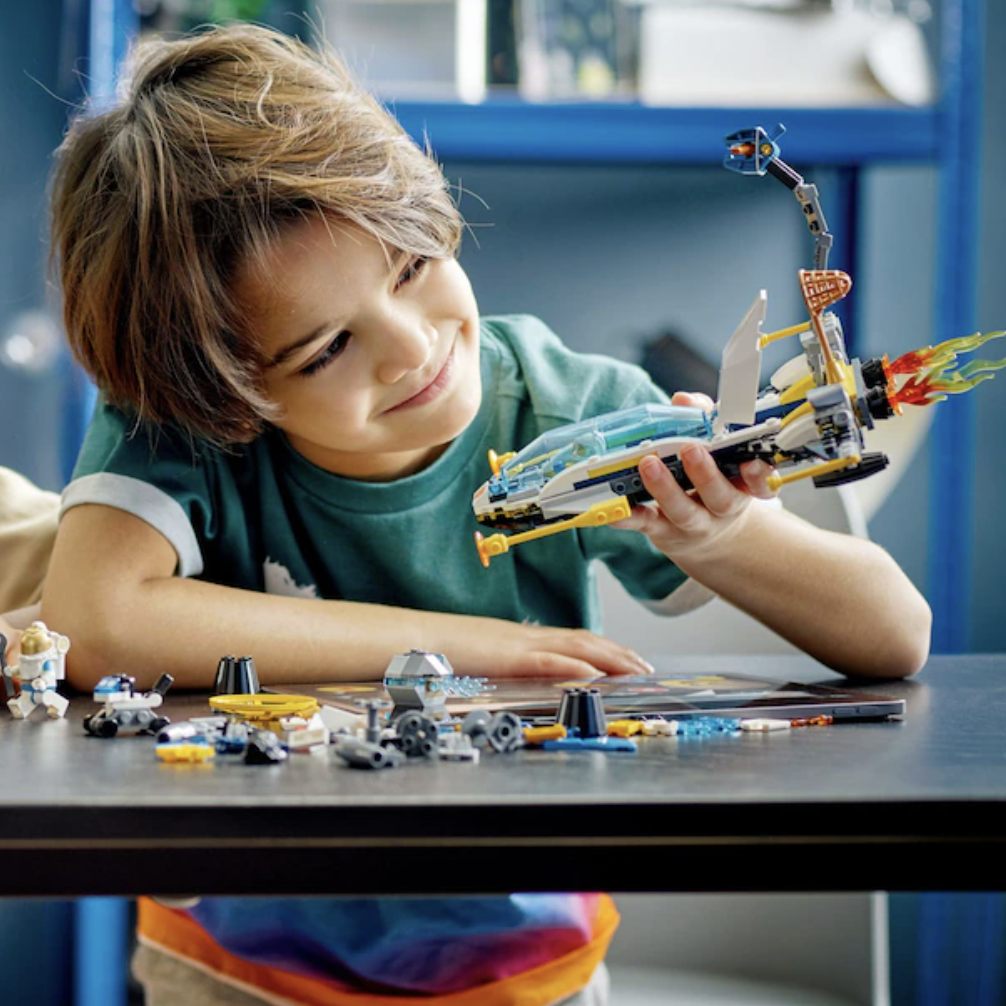 a child playing with the finished spacecraft