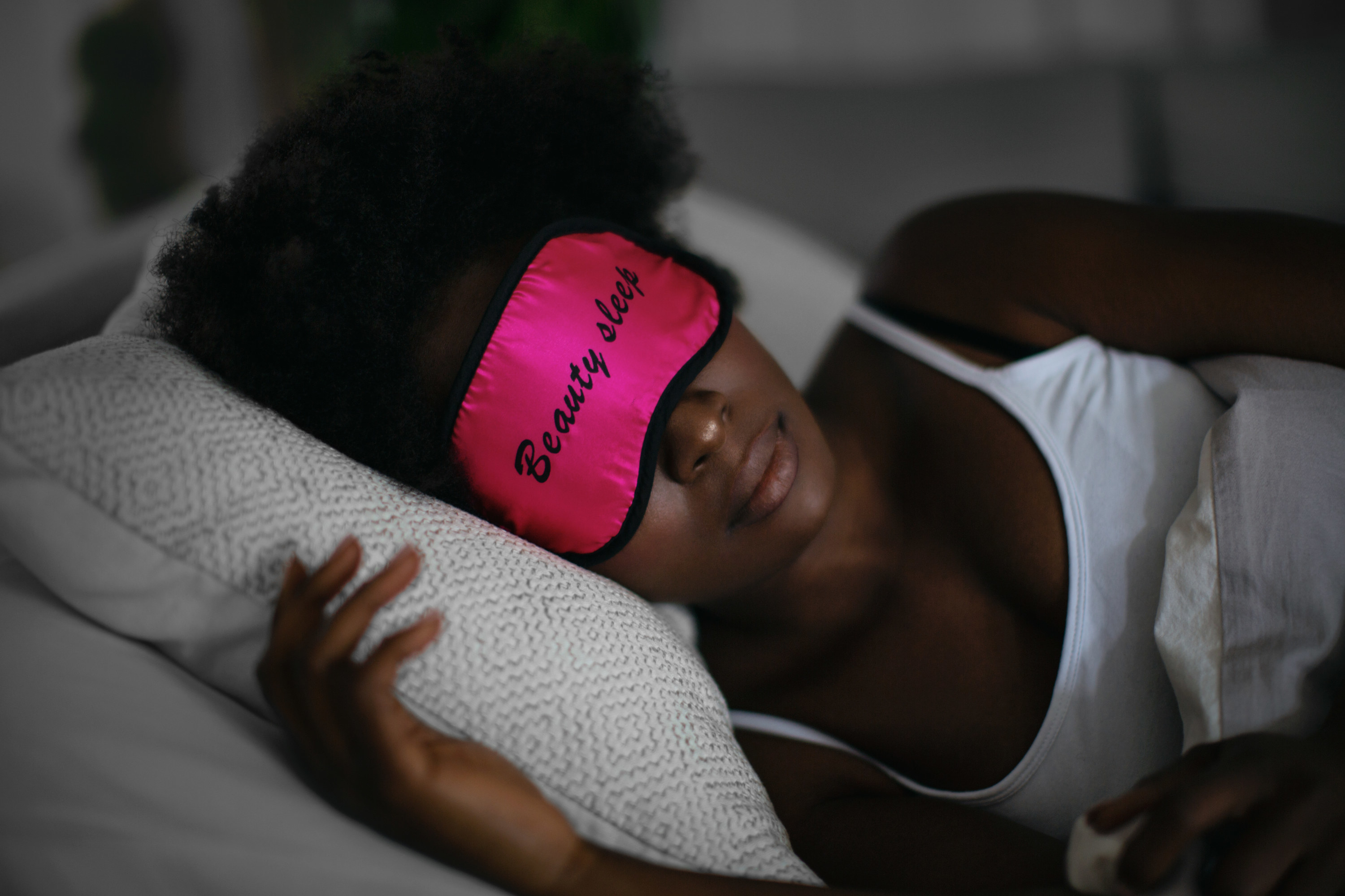 a woman sleeping with an eye mask on
