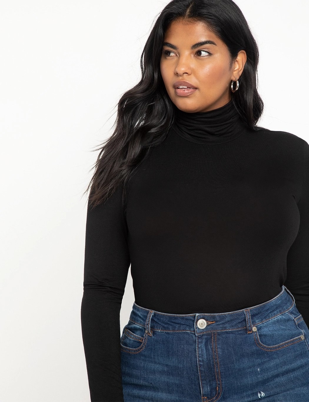 Model wearing black turtleneck top with jeans