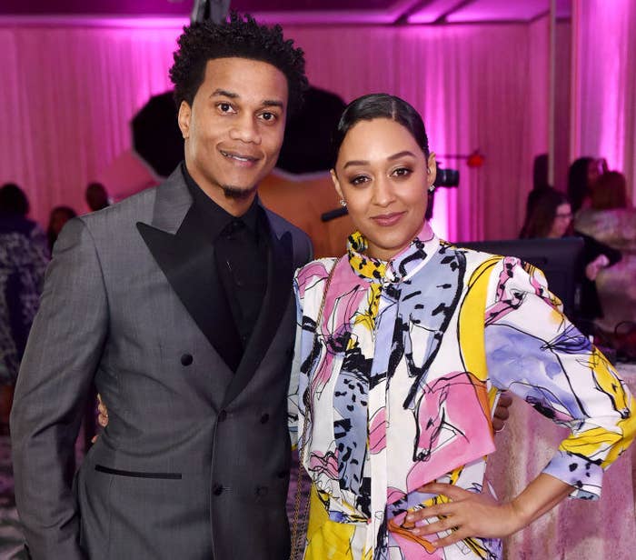 Cory Hardrict and Tia Mowry standing together and smiling