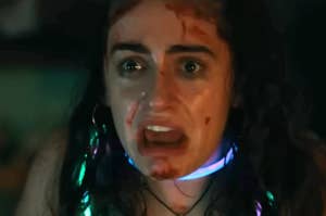 Rachel Sennott screaming while wearing glow necklaces