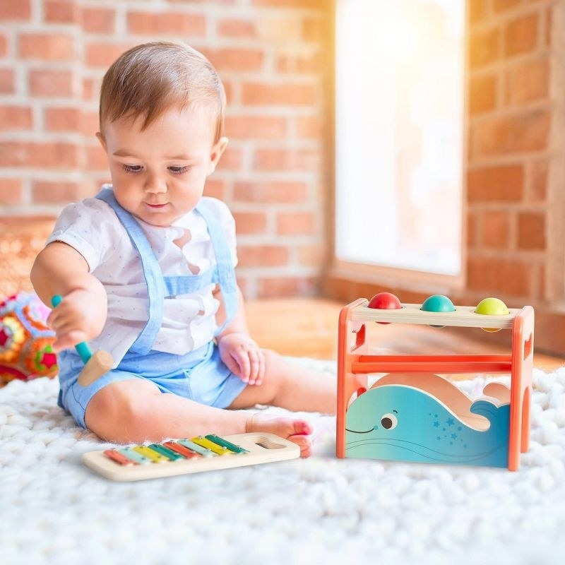 baby with pounding bench and xylophone