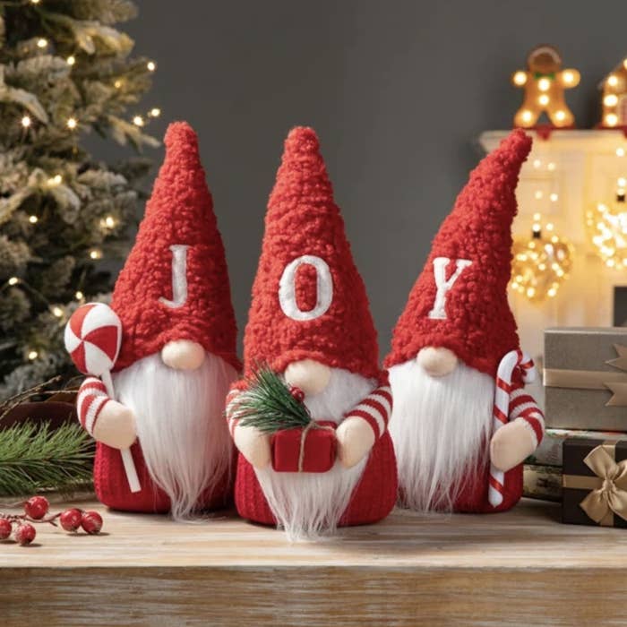 There are three red gnomes that each have one letter on their hats that together spell out &quot;JOY&quot;