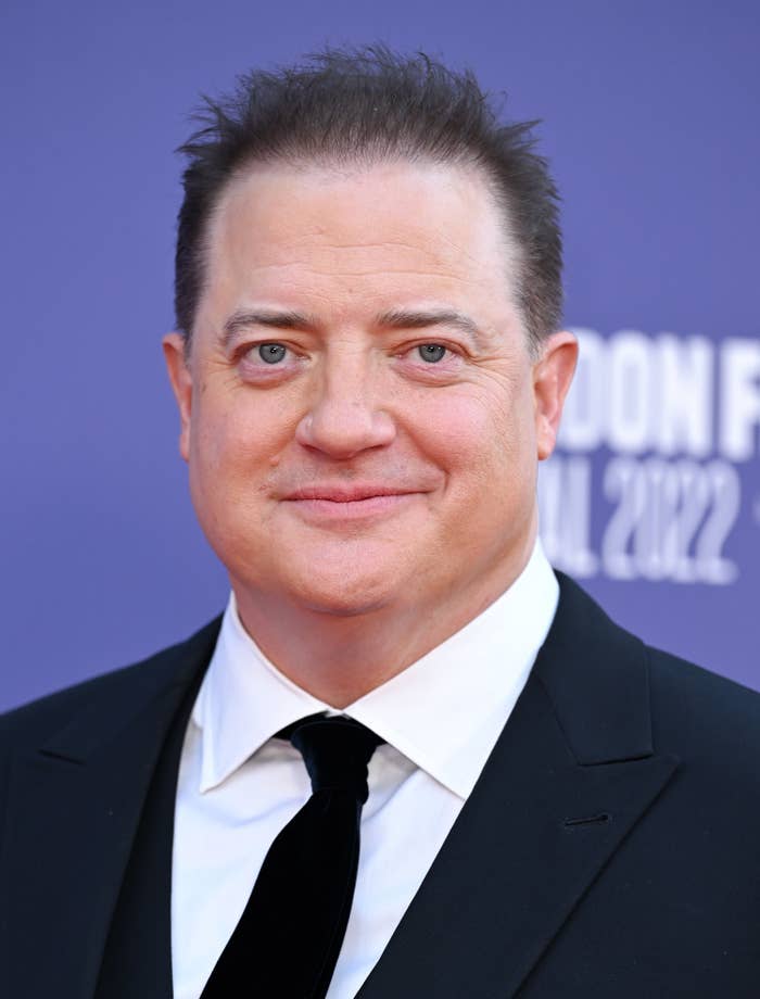 A closeup of Brendan Fraser wearing a suit and tie at a red carpet event