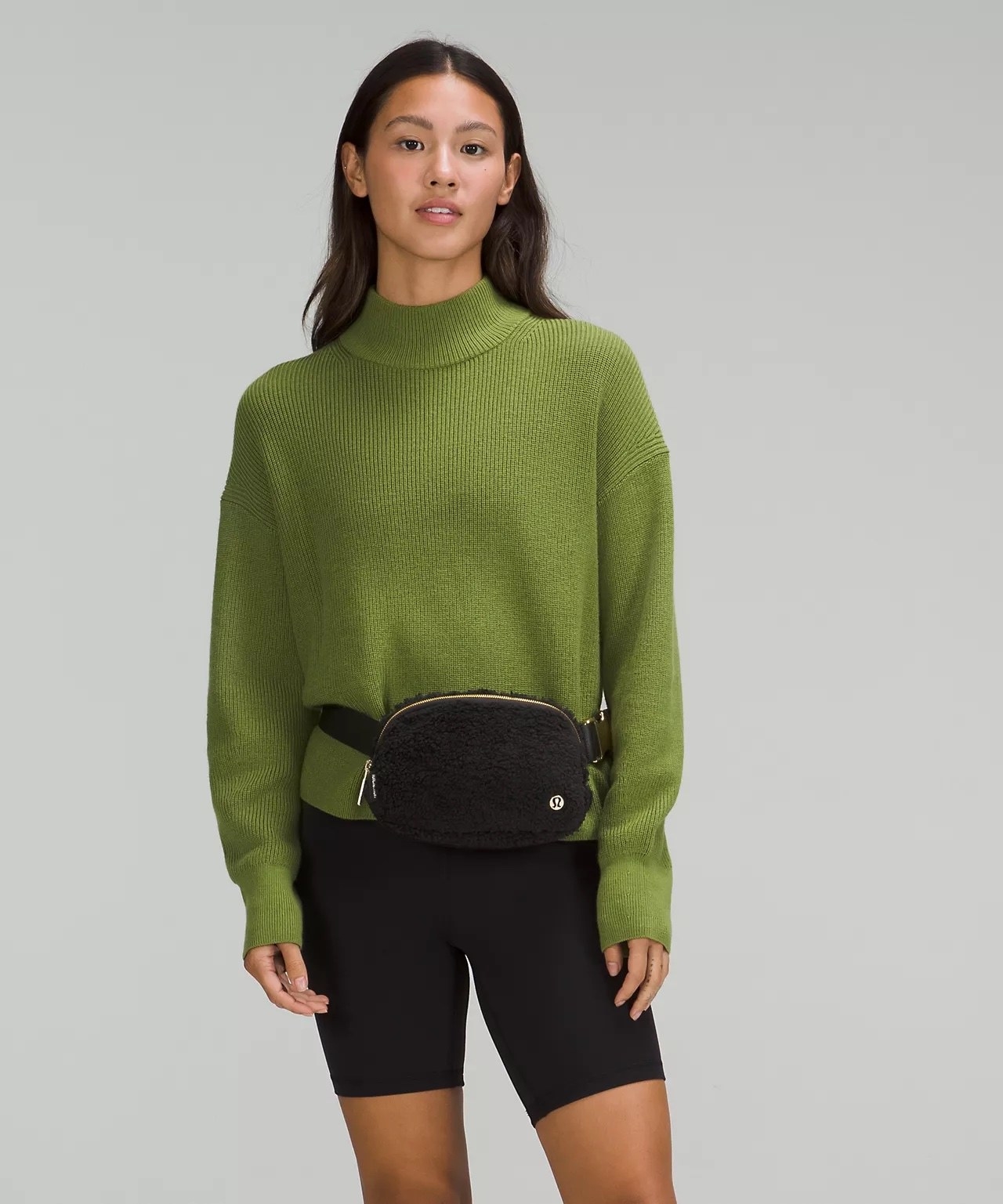 model wearing black fleece belt bag