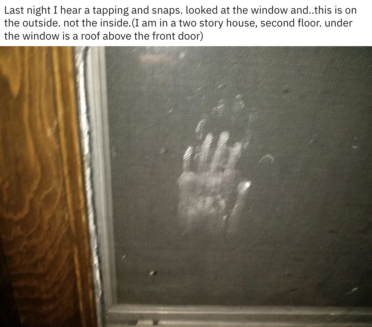 A handprint on a window screen