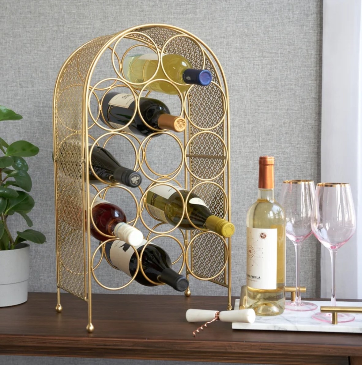 A gold 14-bottle arched wine rack