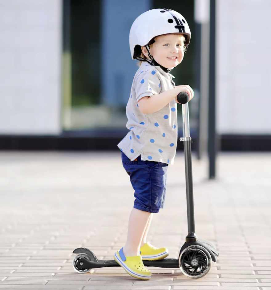a kid using the scooter outside