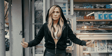 Jennifer Lopez in &quot;Hustlers&quot; puts her hands in the air and money flies out