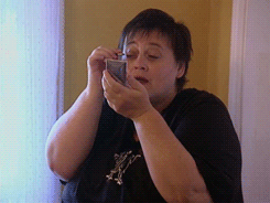 Person applying makeup with a compact