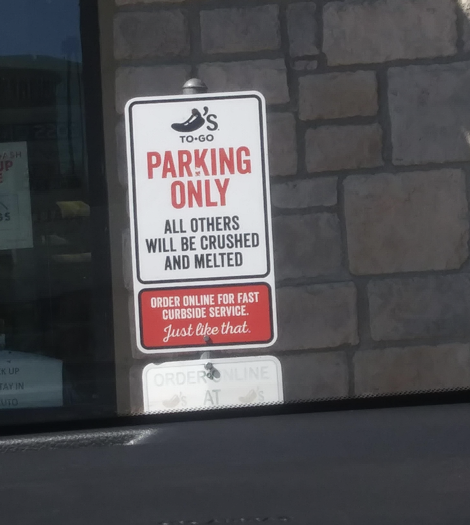 sign reading parking only all other will be crushed and melted