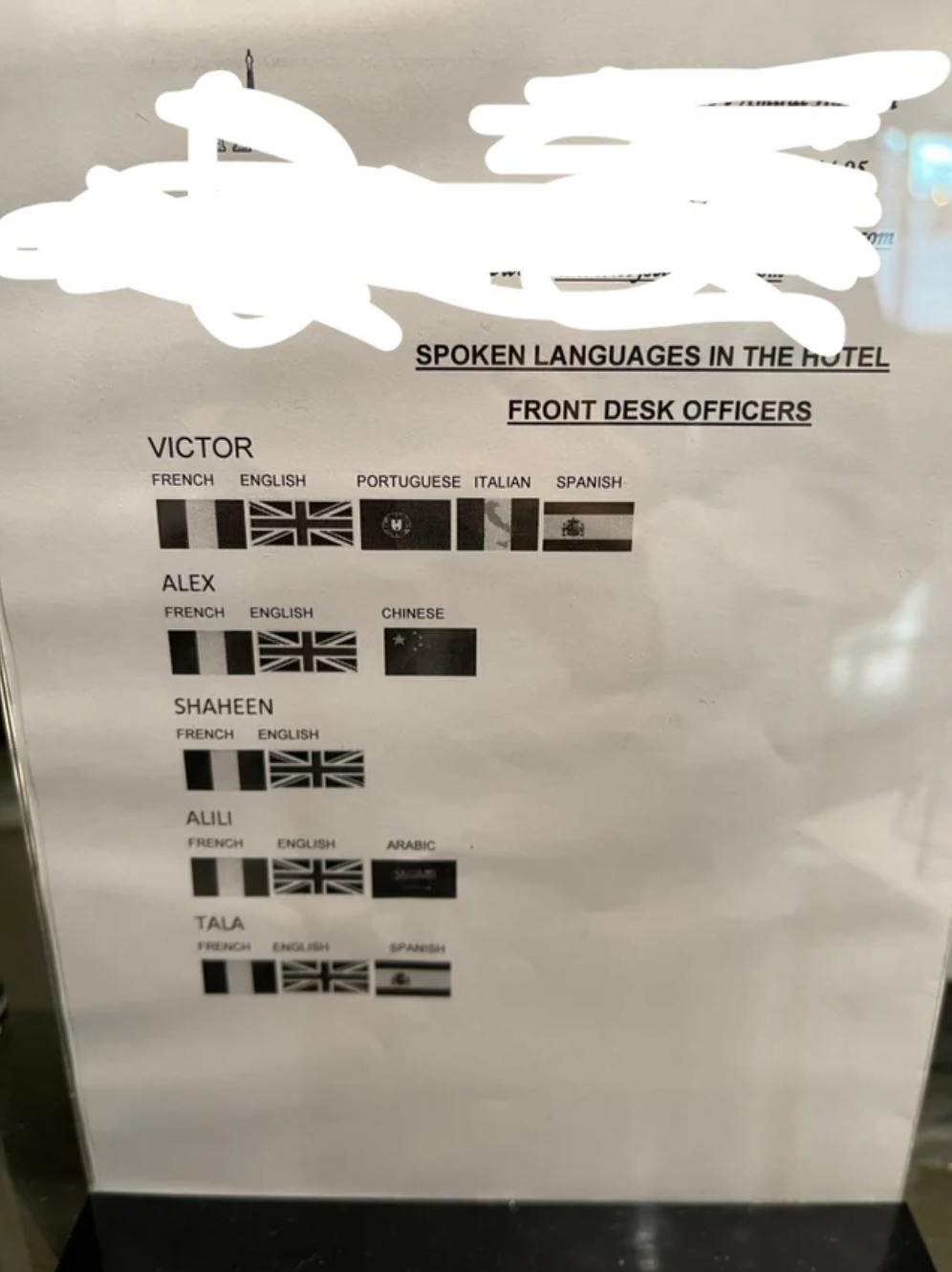 A sign listing the employees and what languages they speak