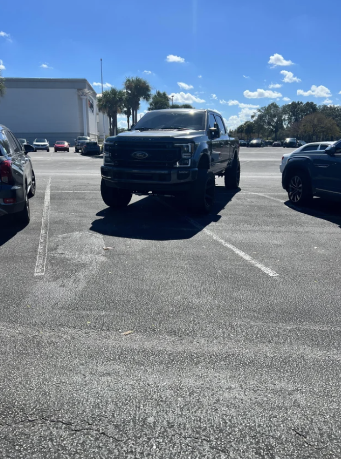 A truck taking up multiple parking spots