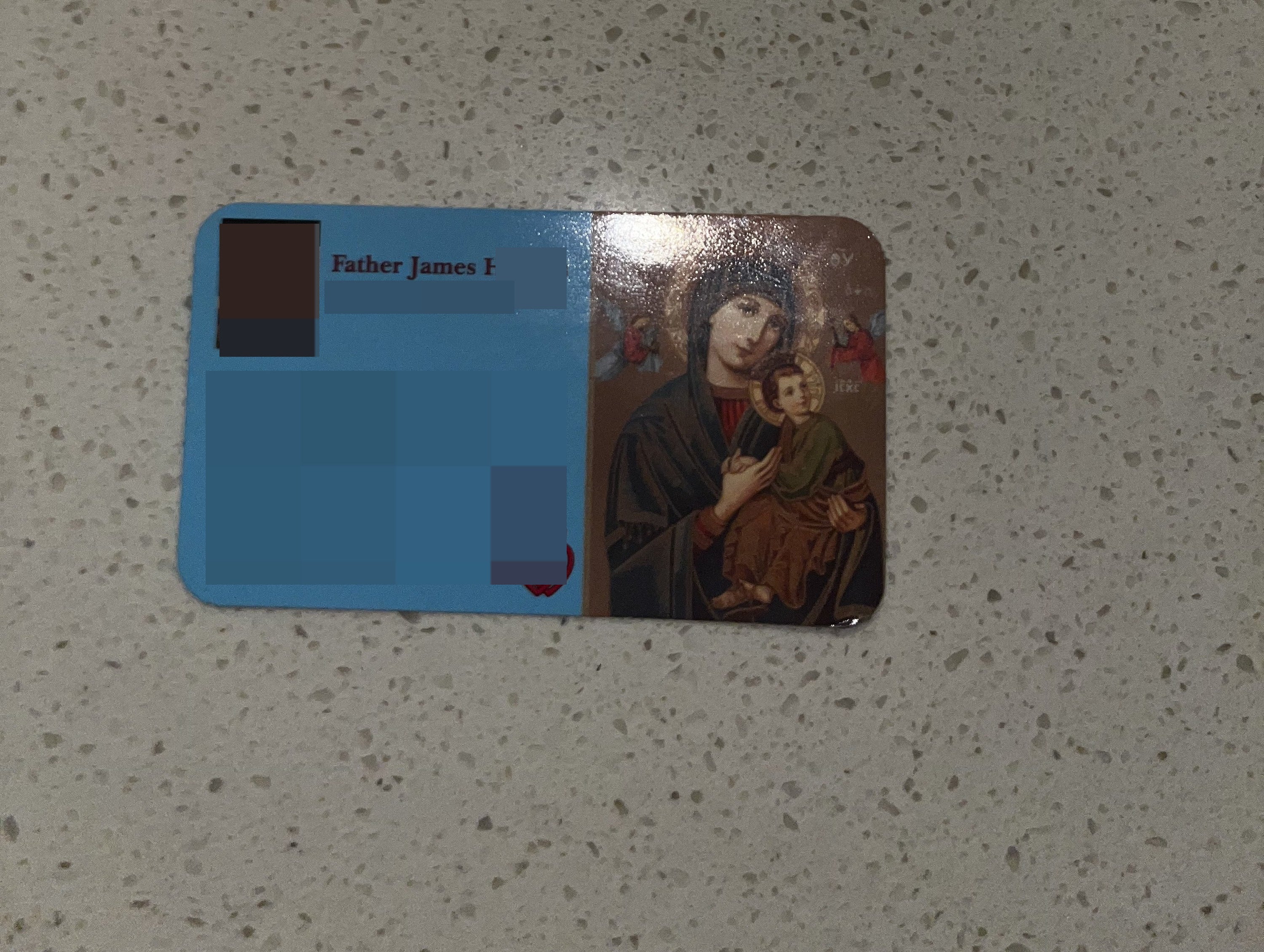 a card with a priest&#x27;s contact info