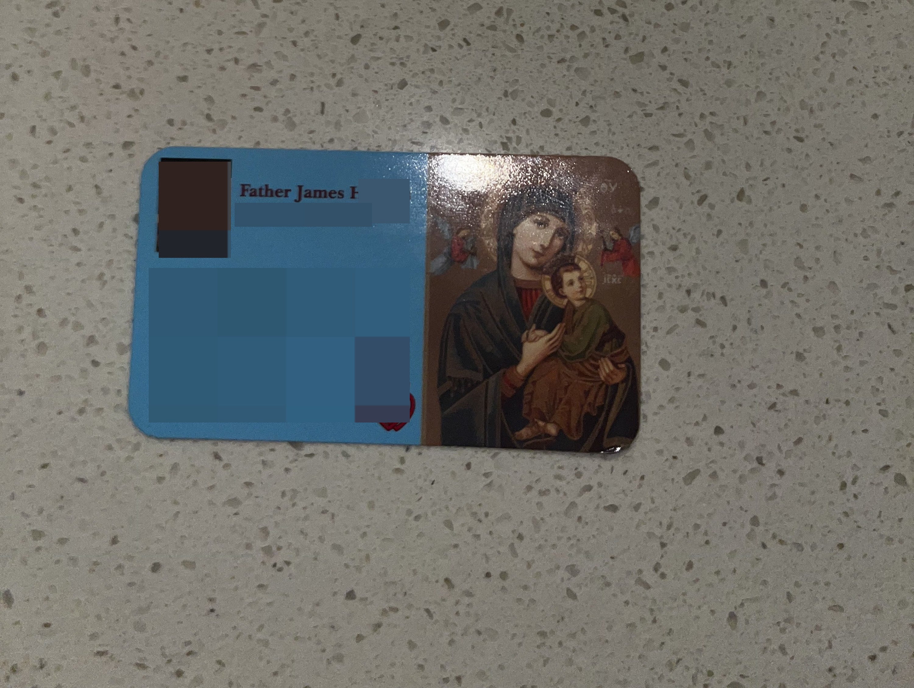 a card with a priest's contact info