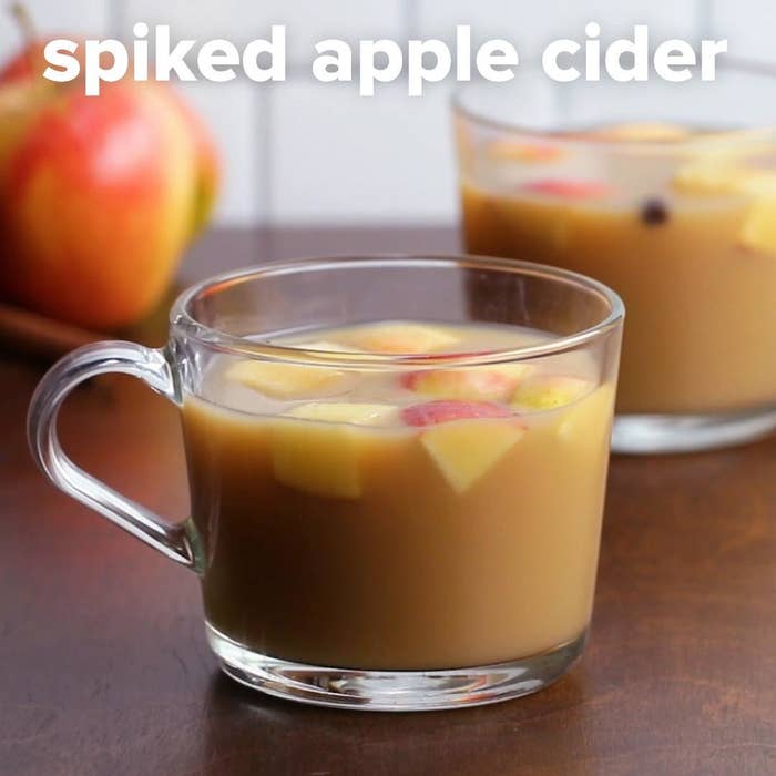 Clear mug of spiked apple cider with apple chunks
