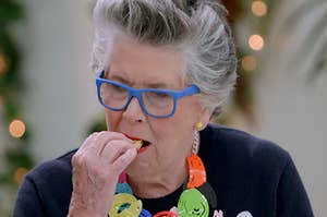 Prue eating a cookie on The Great British Baking Show