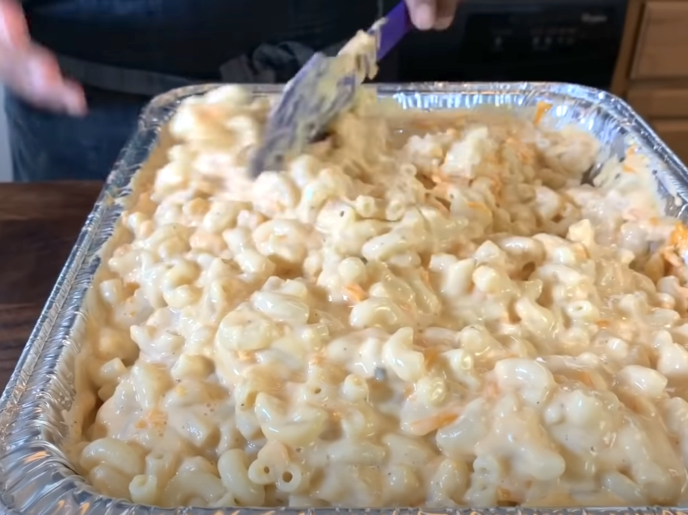 mixing macaroni and cheese in a aluminum foil