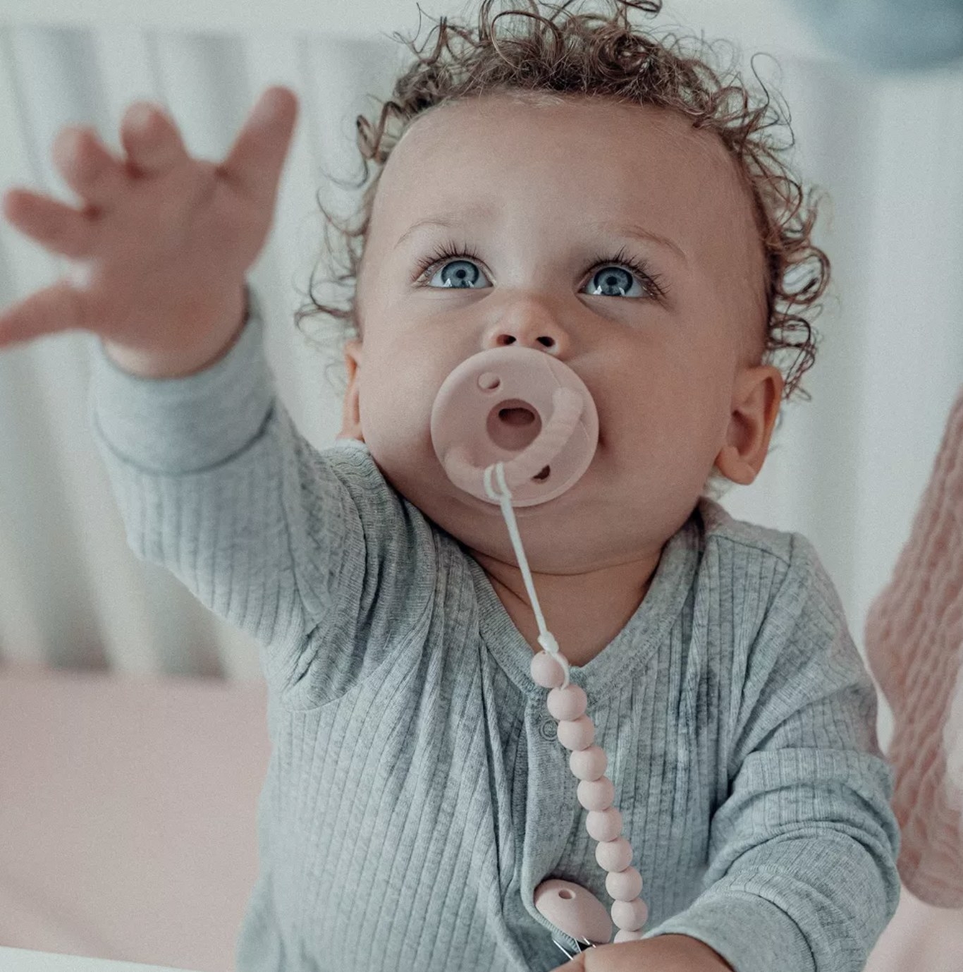 a child with the binky in its mouth