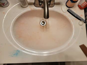 a reviewer before photo of their hair dye stained sink