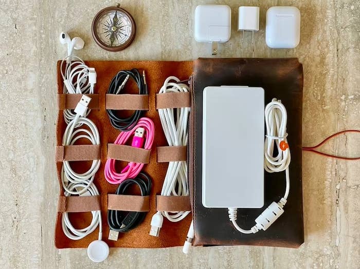 Leather organizer filled with cables and chargers