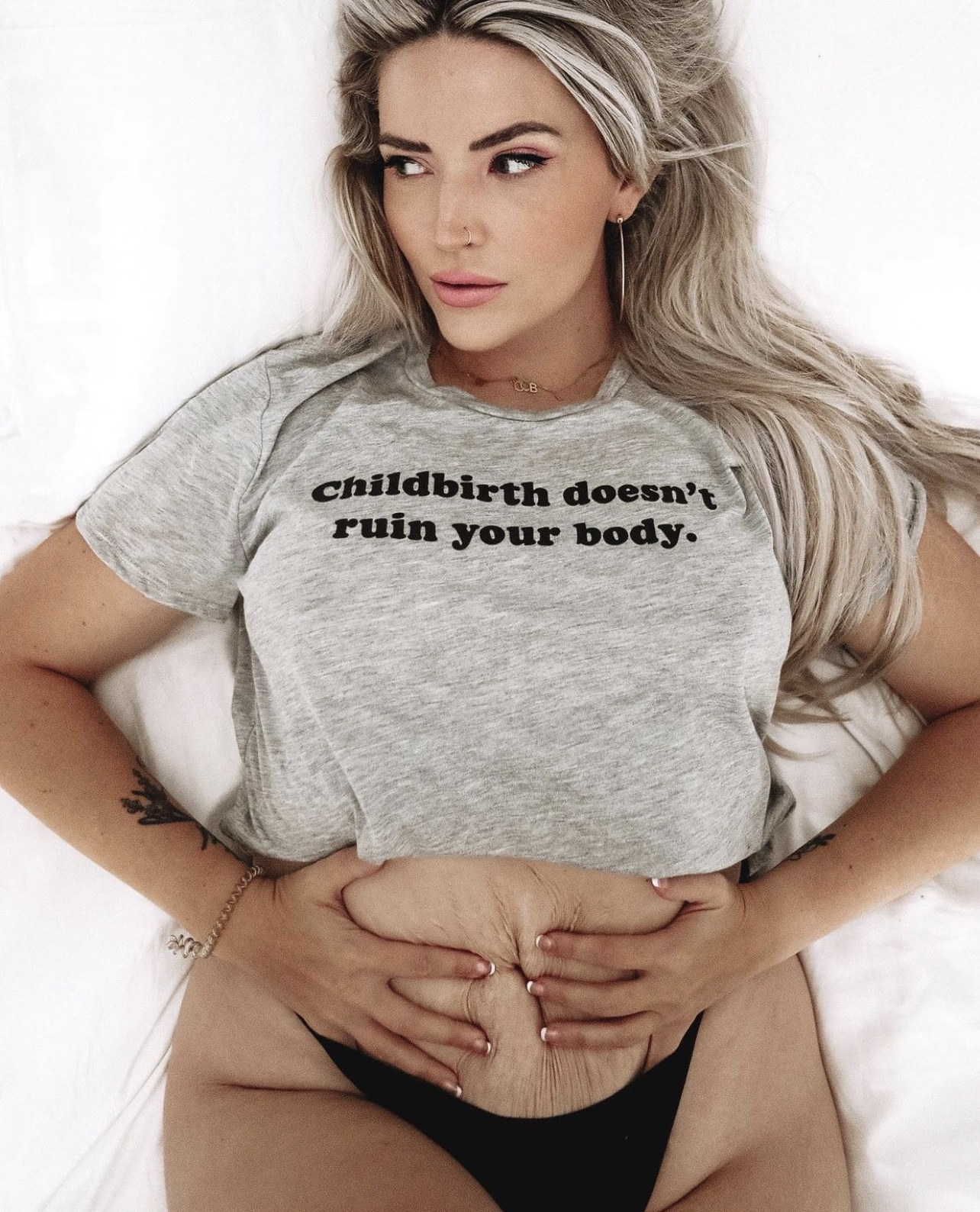 A woman wearing a shirt that says, &quot;childbirth doesn&#x27;t ruin your body&quot;
