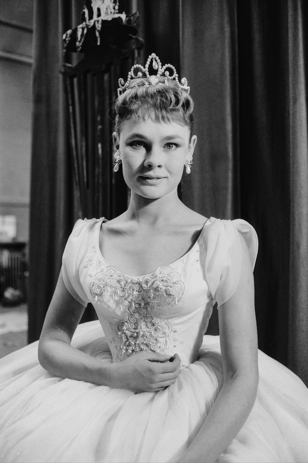 young Judi Dench wearing a gown and tiara