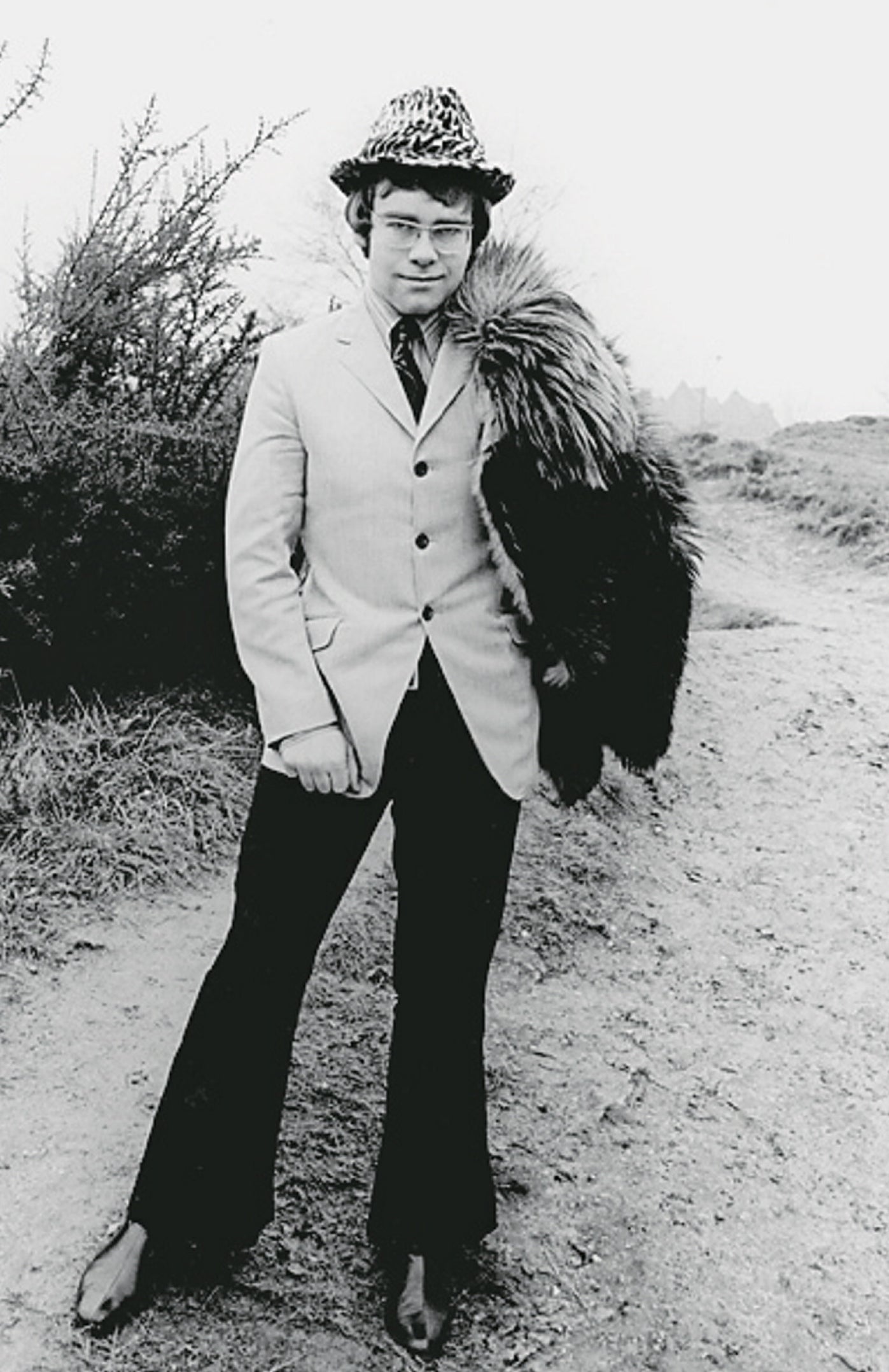 young Elton John in a suit