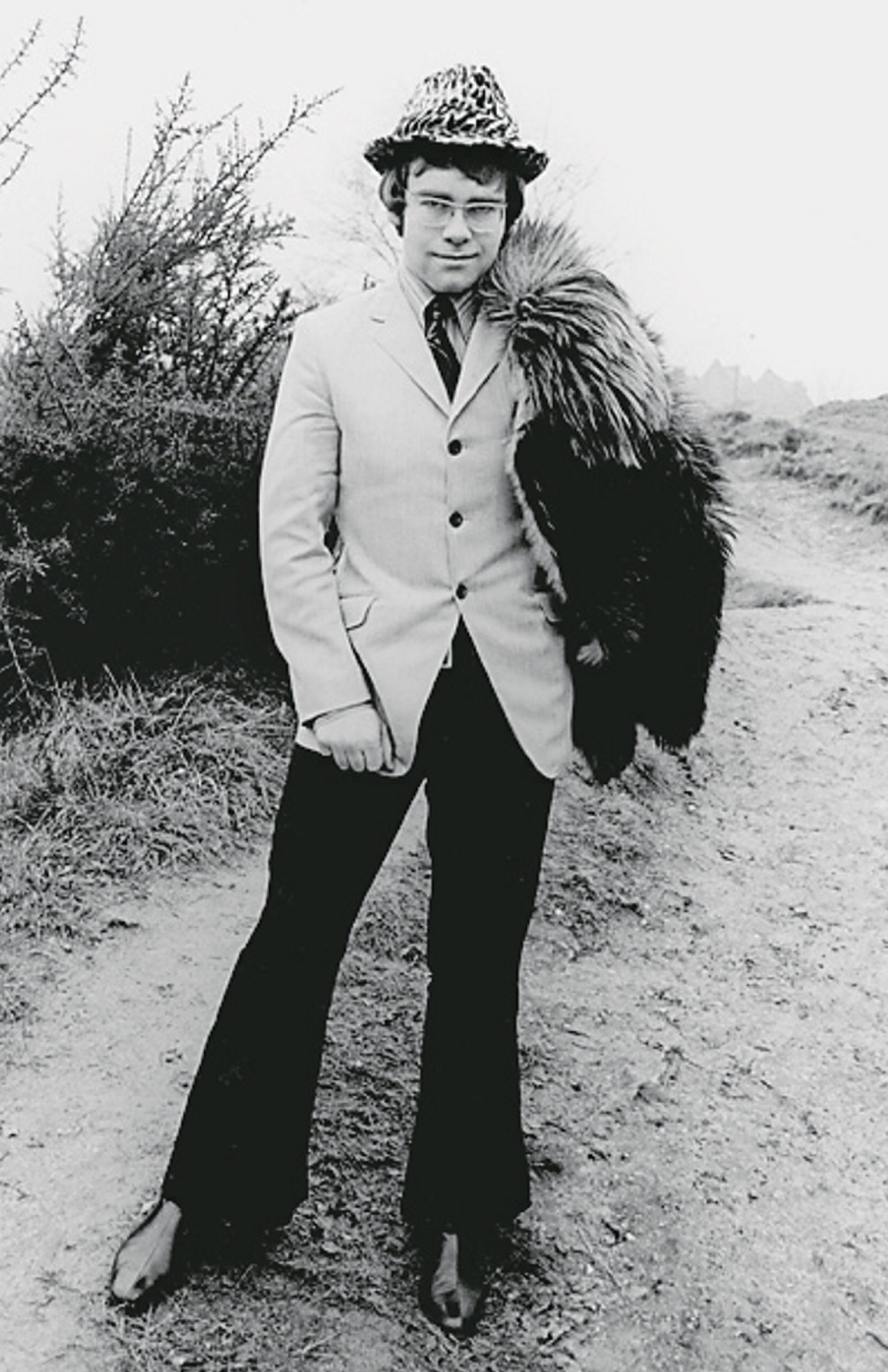 young Elton John in a suit