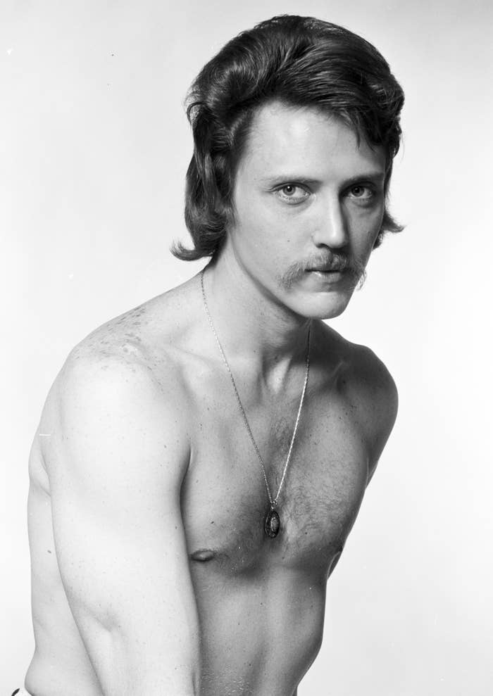 young Christopher Walken without a shirt on and with a mustache