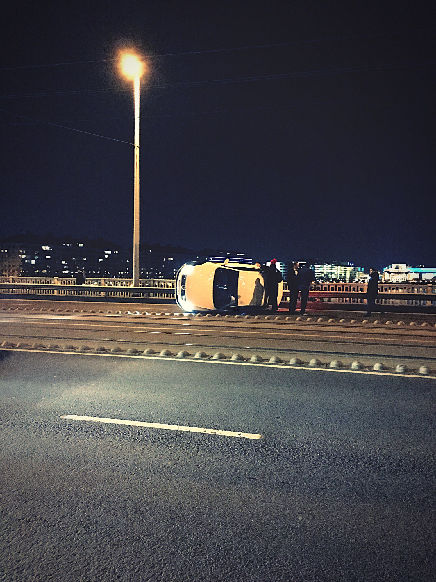 car on side after accident on bridge
