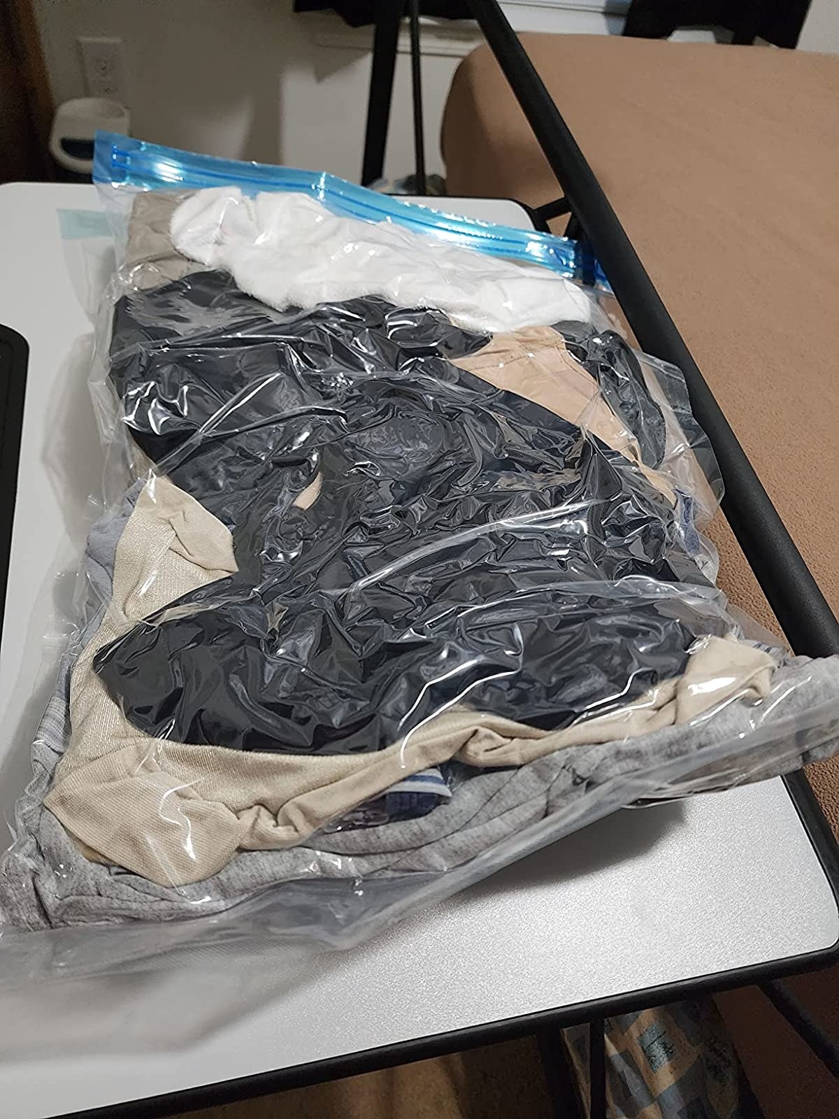 Reviewer image of clothes in a vacuum sealed bag