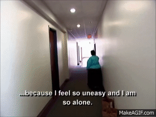 Distraught woman in a hallway saying &quot;Because I feel so uneasy and I am so alone&quot;