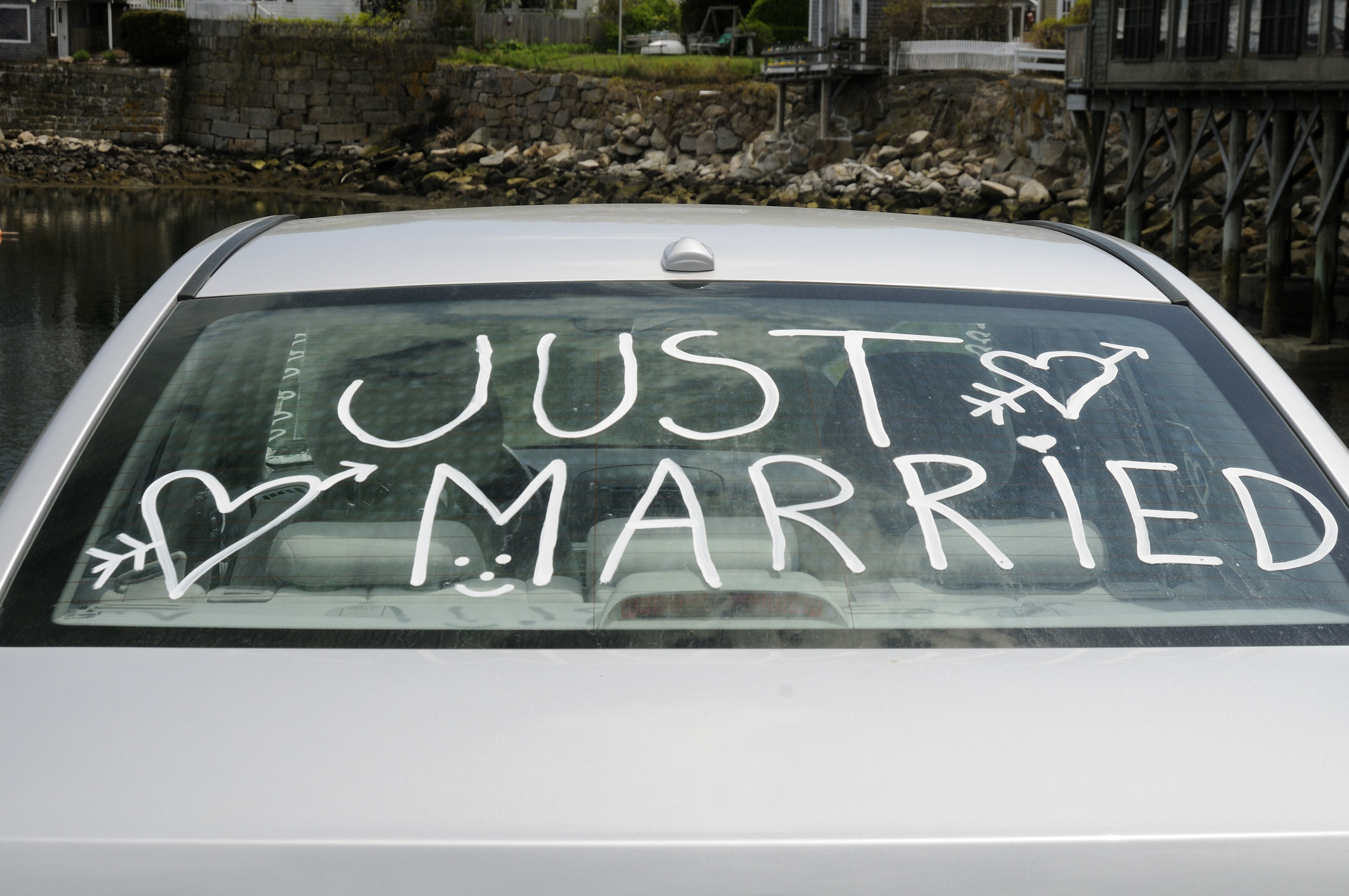 car back window that says just married