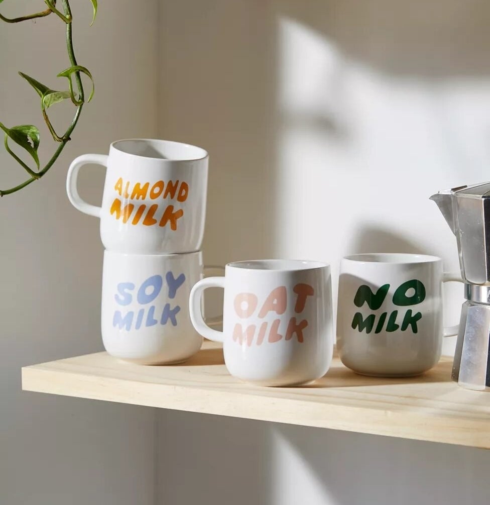 the four milk mugs on a shelf