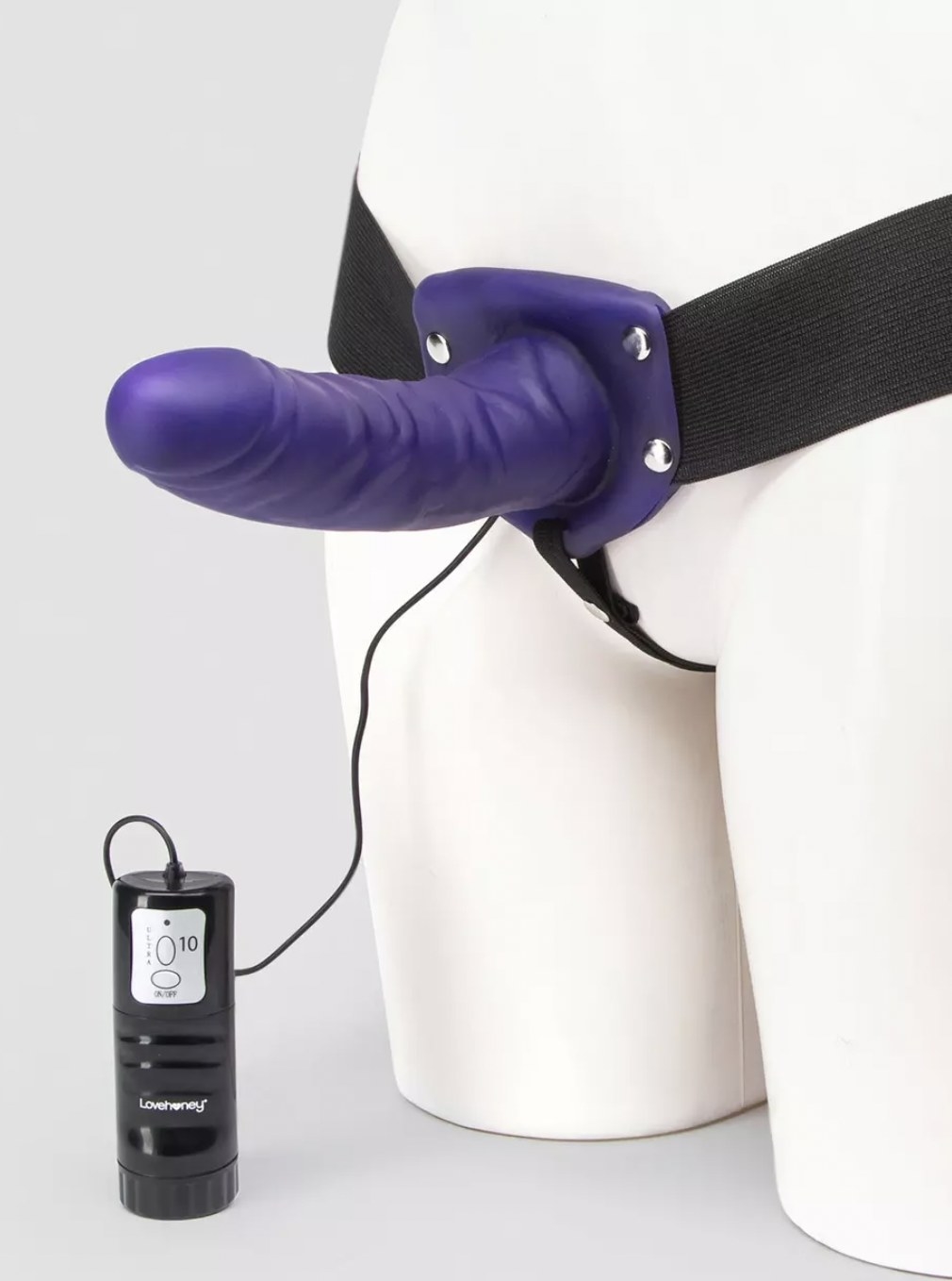 mannequin with purple strap-on secured and attached to vibration control device