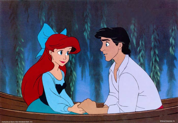 Ariel and Prince Eric from The Little Mermaid in a boat and holding hands