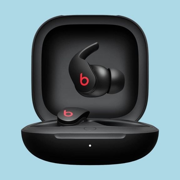 A pair of Beats earbuds and their carrying case