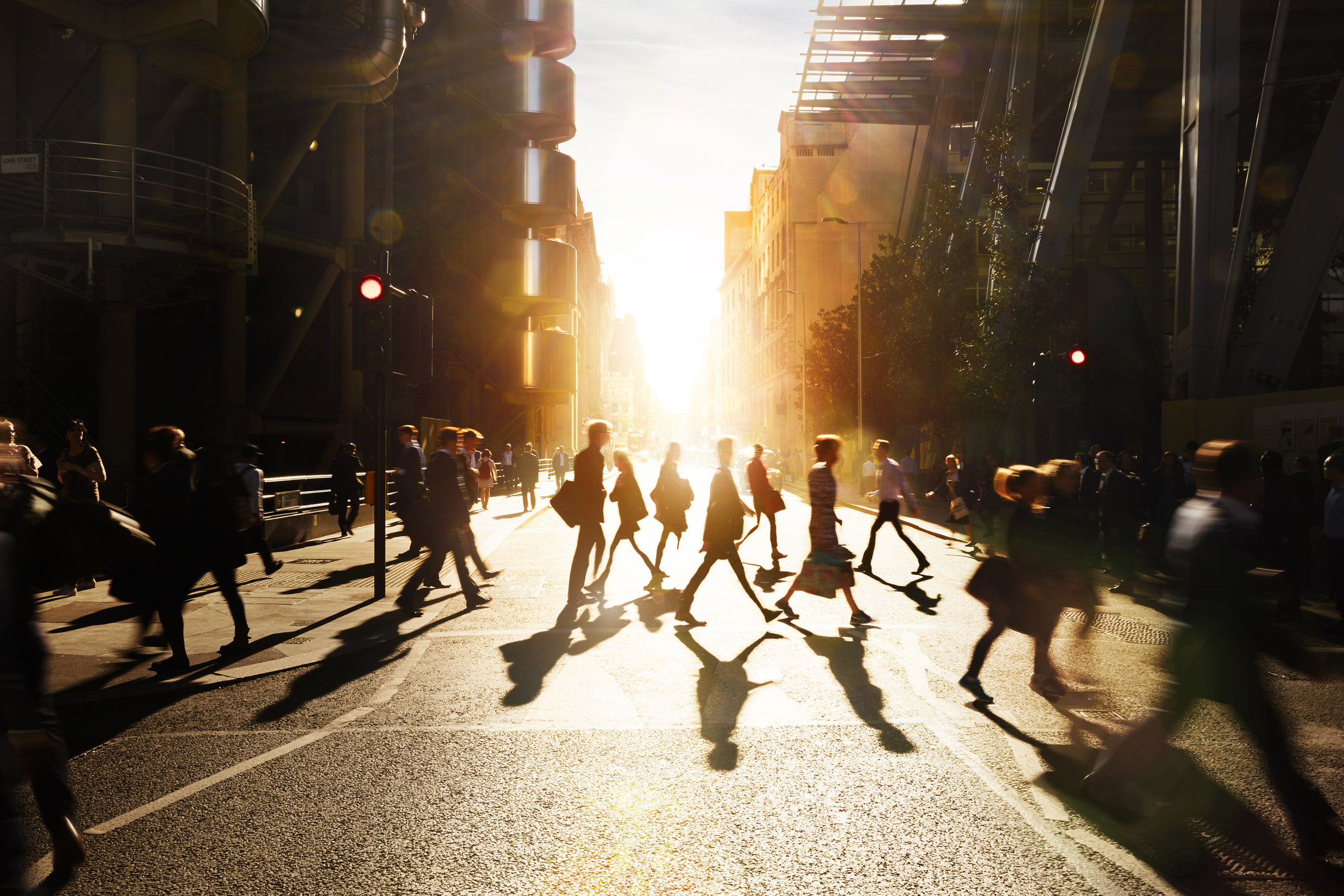 Businesspeople walking across a city street