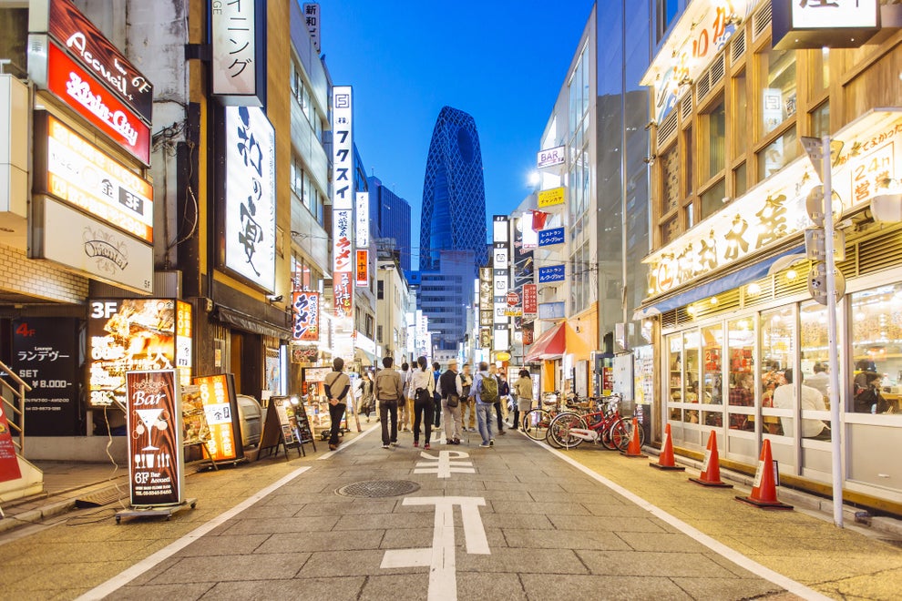 Street with shops and restaurants in Shinjuku district in Tokyo