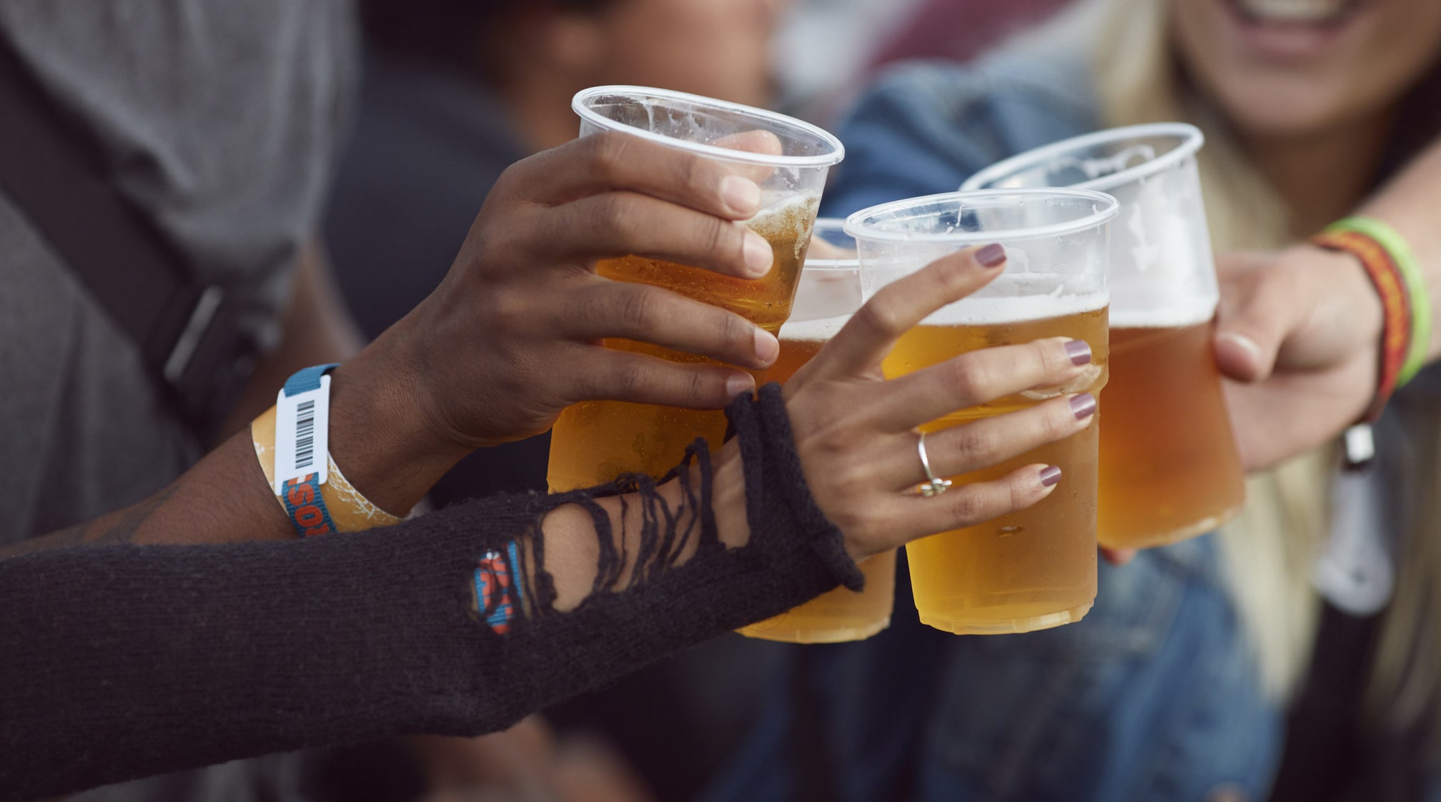 Friends clinking cups of beer