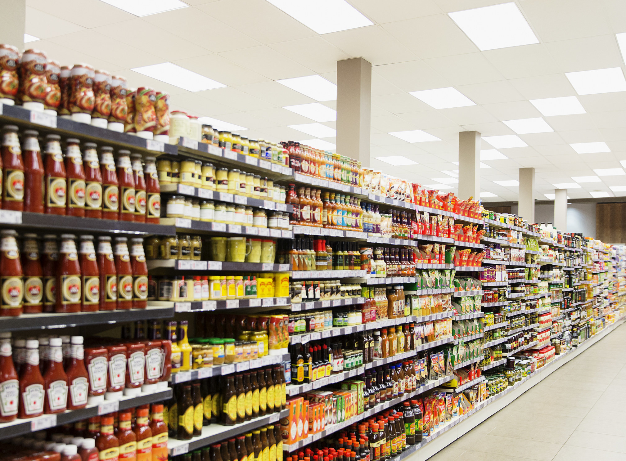 Stocked shelves in grocery store aisle